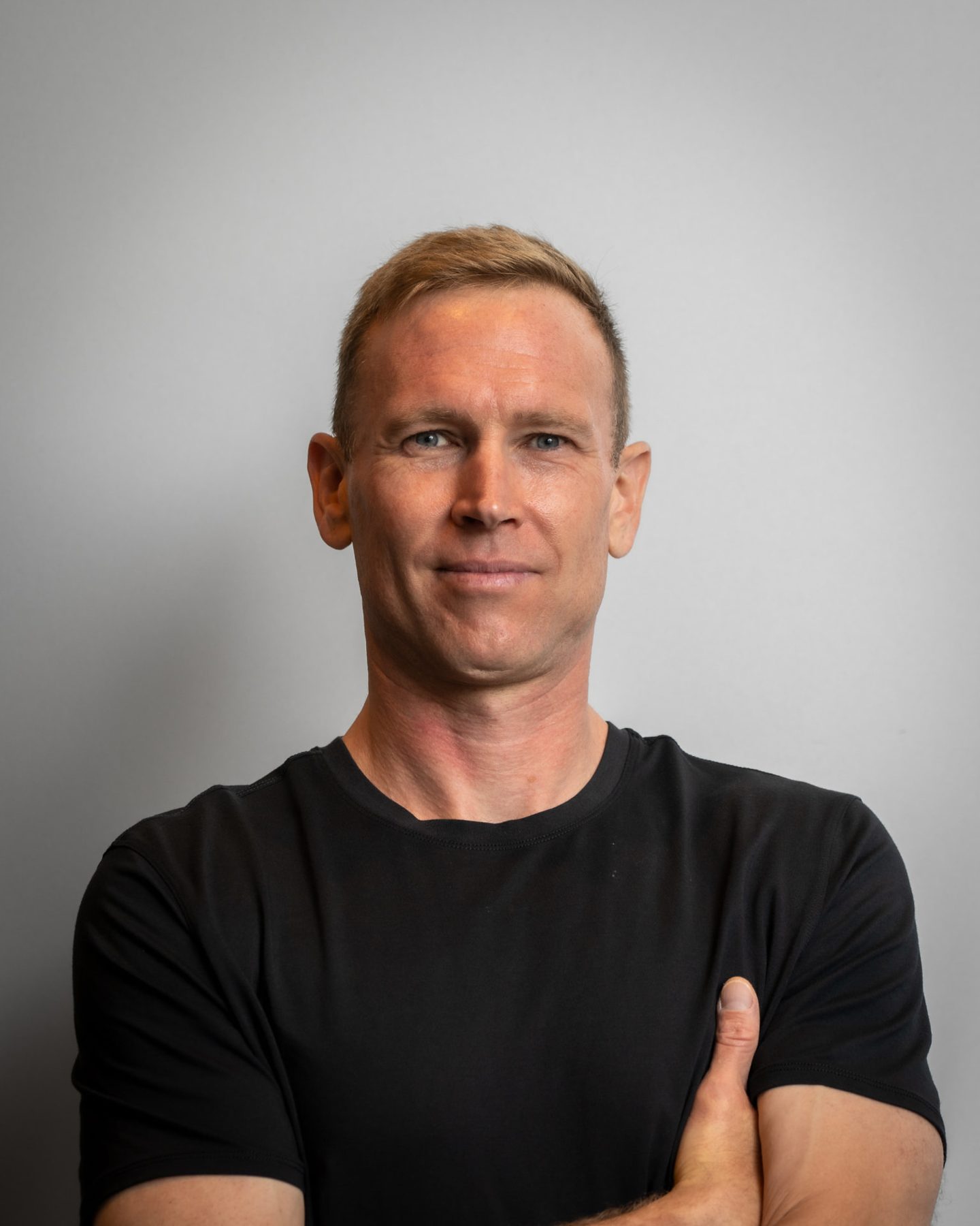Portrait of Christopher Gillett in a black t-shirt