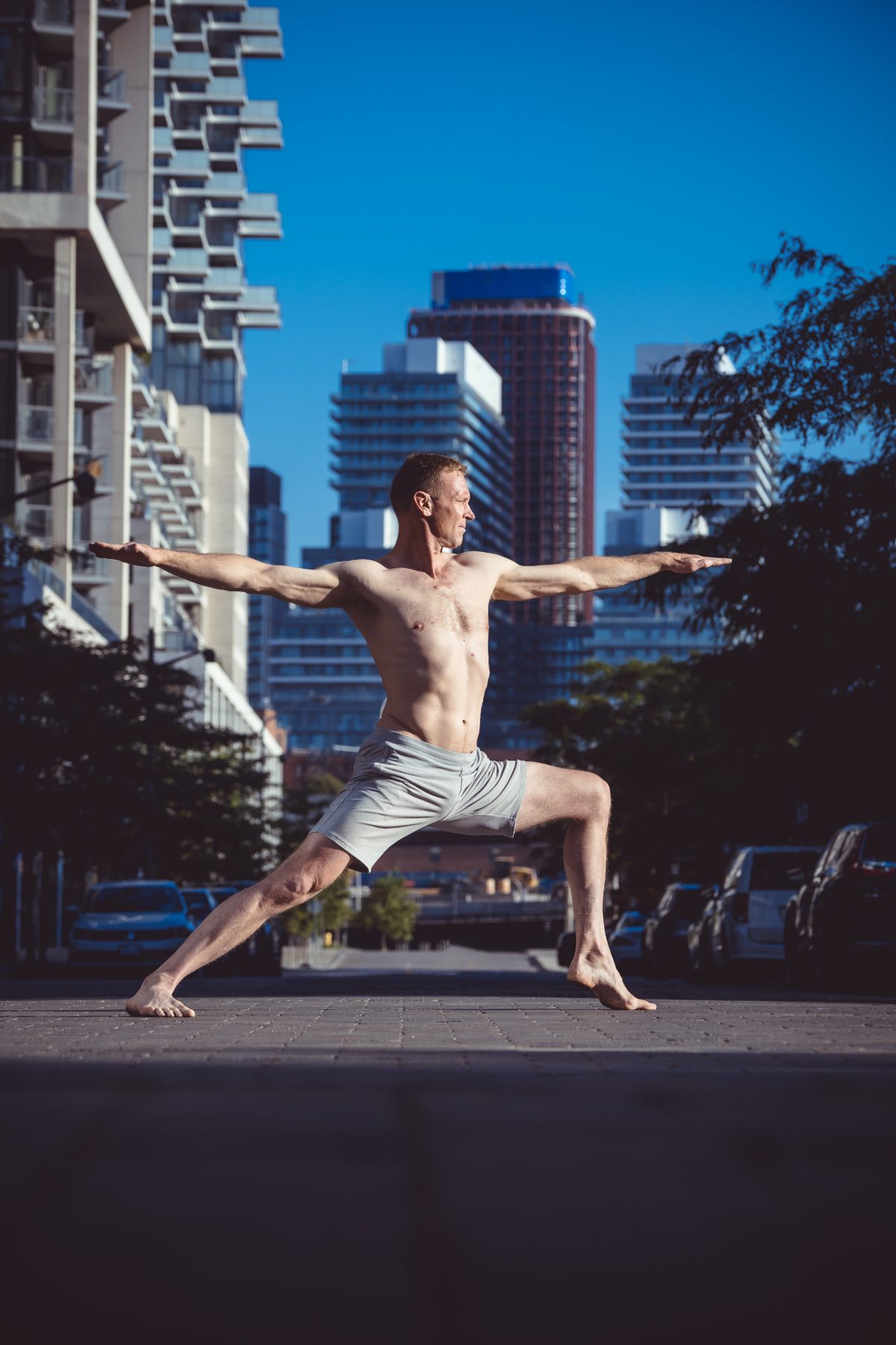 Christopher Gillett in warrior two with the Toronto skyline behind